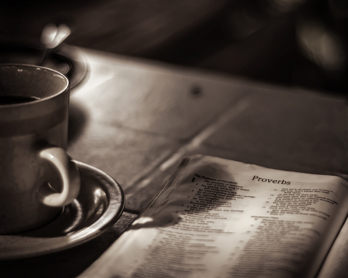 Bible open to Proverbs and Coffee